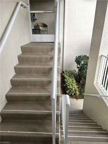 Stairs featuring a textured wall