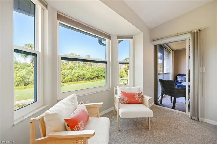 Sitting room with carpet floors and lofted ceiling