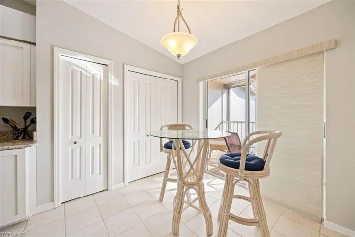 Dining space featuring vaulted ceiling and light tile patterned floors