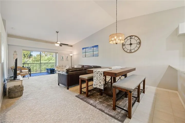 Dining space featuring lofted ceiling, ceiling fan, and a chandelier