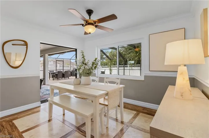 Dining area with ceiling fan, hardwood / wood-style flooring, and ornamental molding
