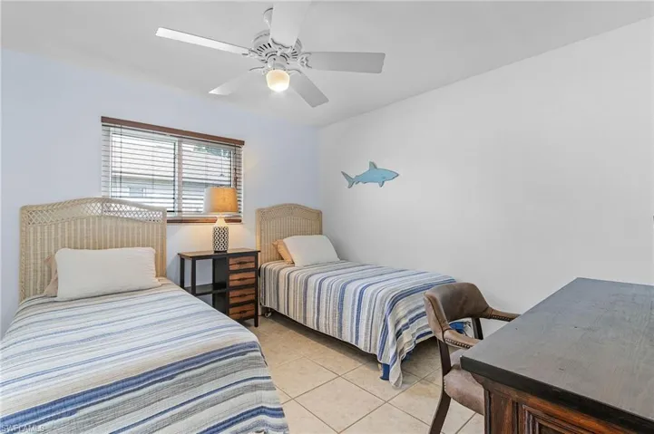 Bedroom featuring light tile patterned floors and ceiling fan