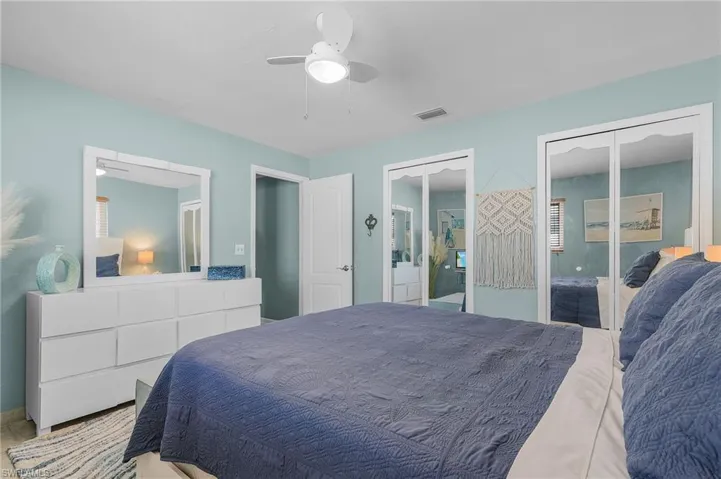 Bedroom with ceiling fan, and two closets