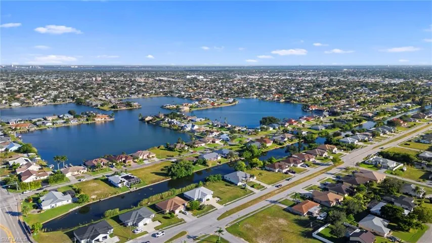 Aerial overview of property's location with nearby suburban area and a nearby body of water