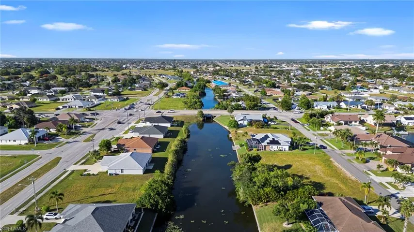 View of property location with nearby suburban area and a nearby body of water