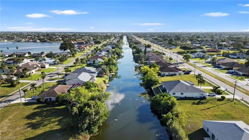 Aerial perspective of suburban area with a nearby body of water