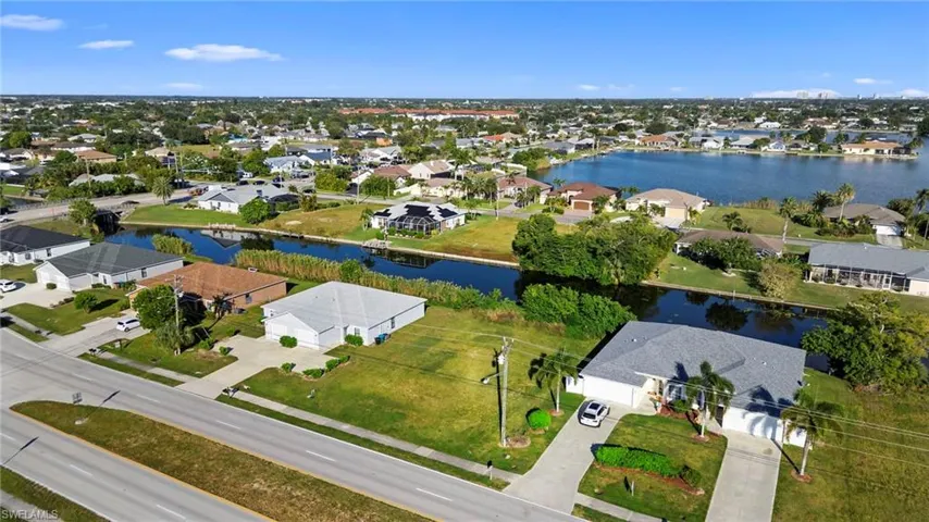 Aerial perspective of suburban area with a nearby body of water
