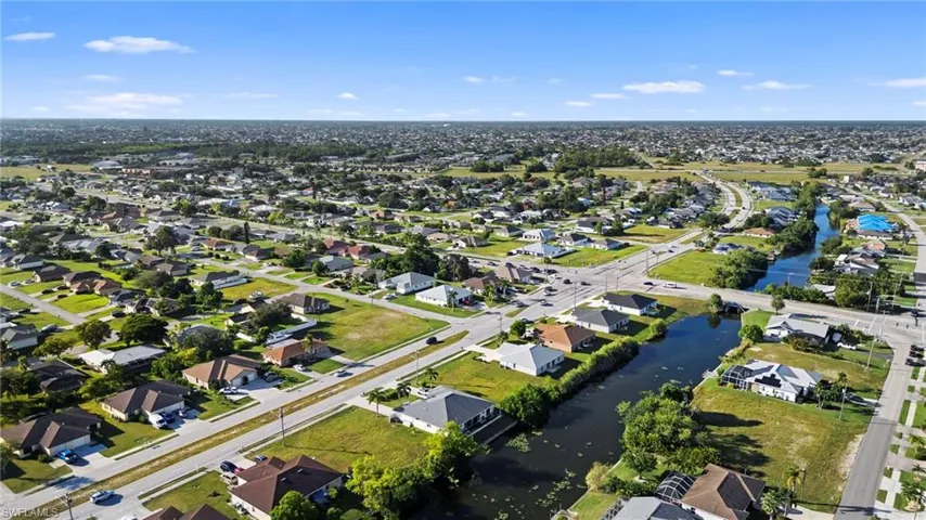 Aerial overview of property's location featuring nearby suburban area and a nearby body of water