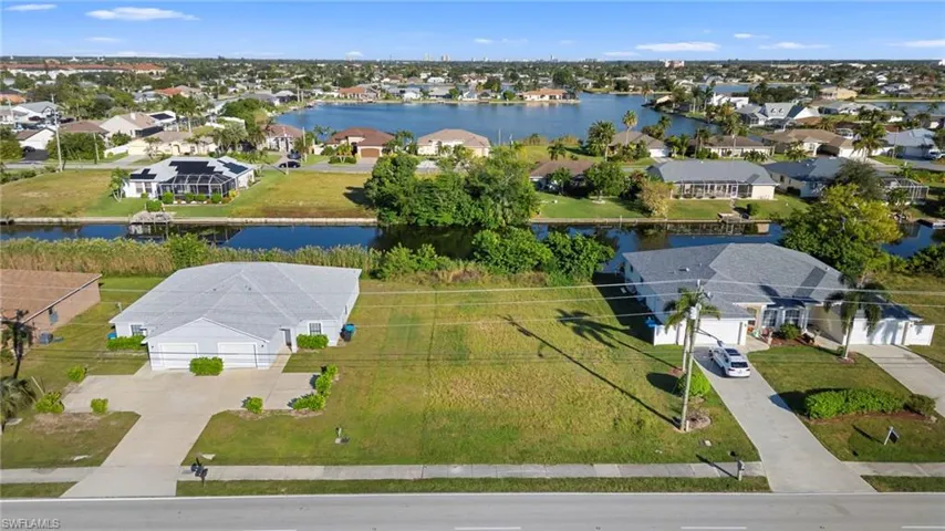 Aerial perspective of suburban area featuring a large body of water