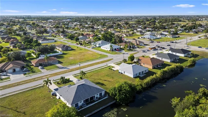 Aerial view of residential area featuring a large body of water
