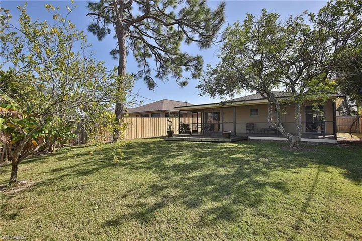 View of yard with a wooden deck and a fenced backyard