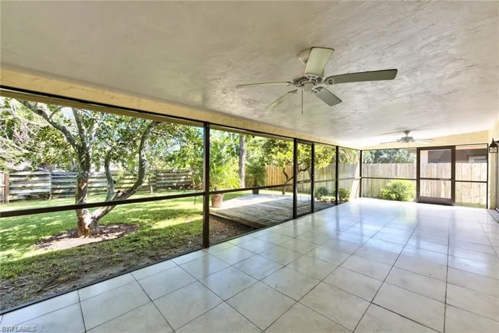 Unfurnished sunroom with ceiling fan