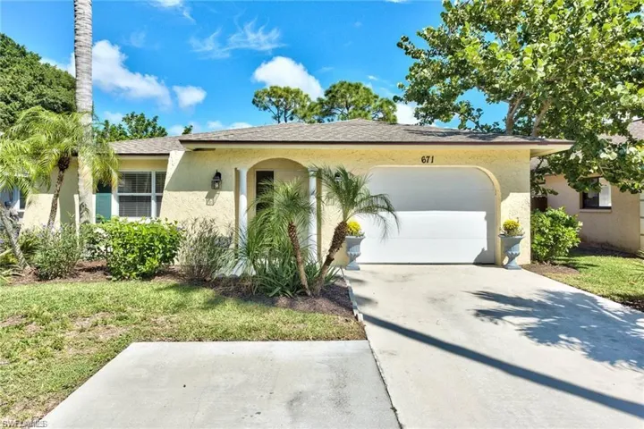 Single story home featuring an attached garage, driveway, and stucco siding