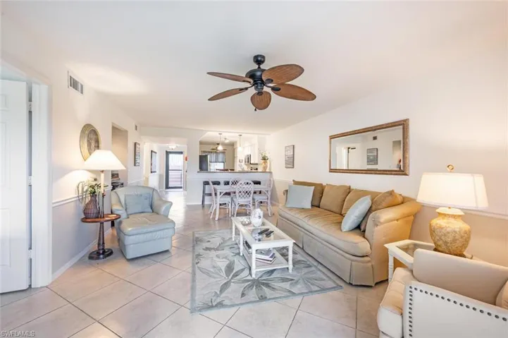 Living room featuring tile patterned floors and a ceiling fan