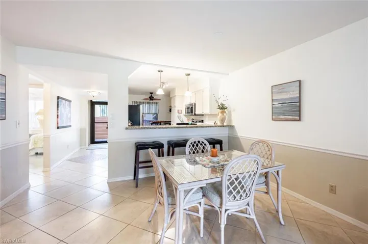 Dining space featuring light tile patterned flooring and baseboards