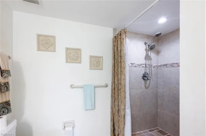 Bathroom featuring a stall shower and toilet