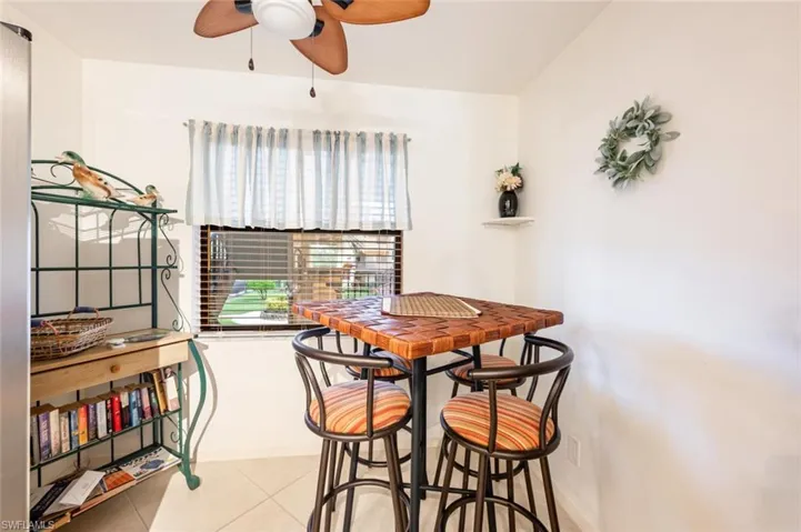 Dining room featuring light tile patterned flooring and ceiling fan