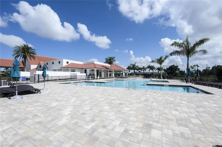 Community pool featuring a patio