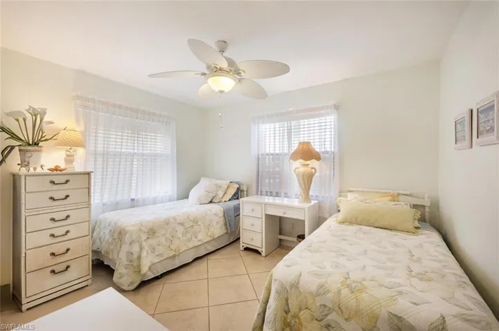 Bedroom with light tile patterned flooring and a ceiling fan