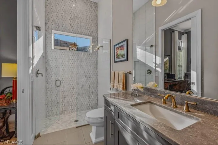 Bathroom with a stall shower and vanity