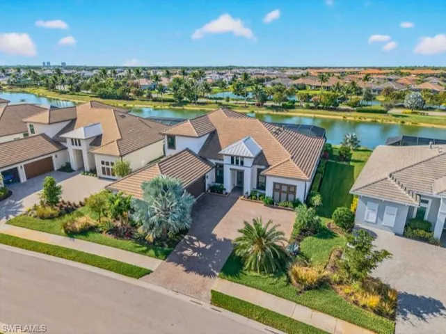Aerial view of residential area featuring a nearby body of water