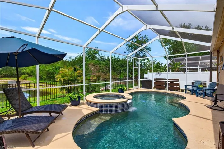 Integrated pool / spa featuring a fenced backyard, a sunroom, a lanai, and a patio area
