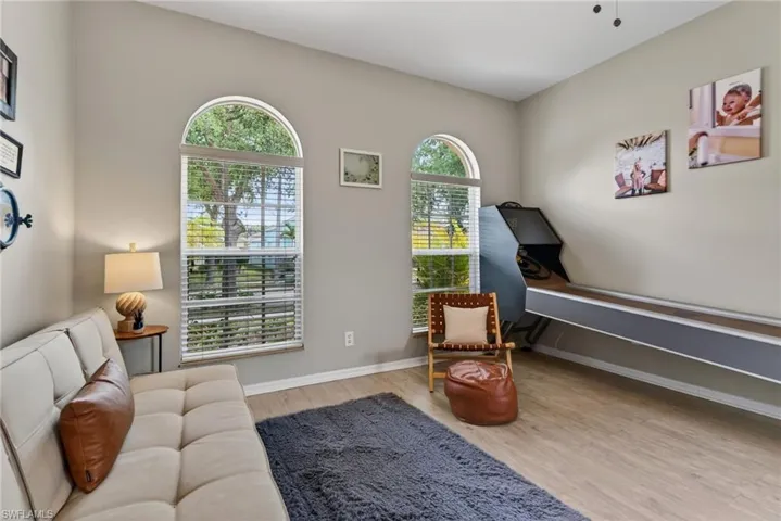 Sitting room with light wood-type flooring and baseboards