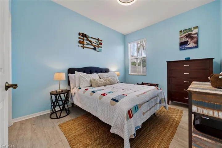 Bedroom featuring light wood-type flooring and baseboards