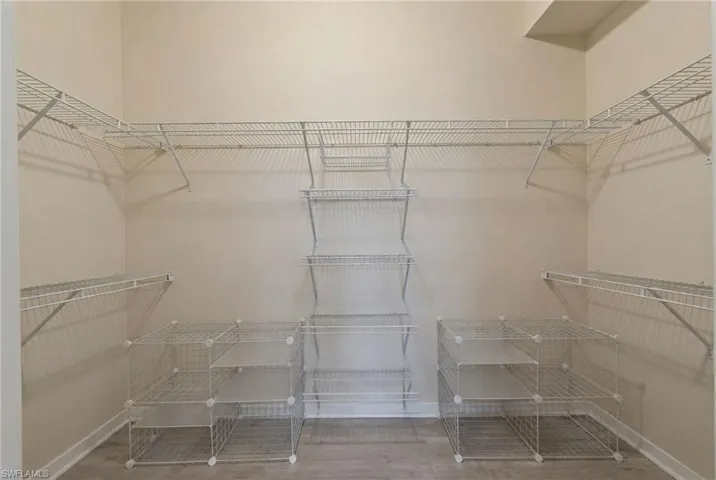 Walk in closet featuring light wood-style floors