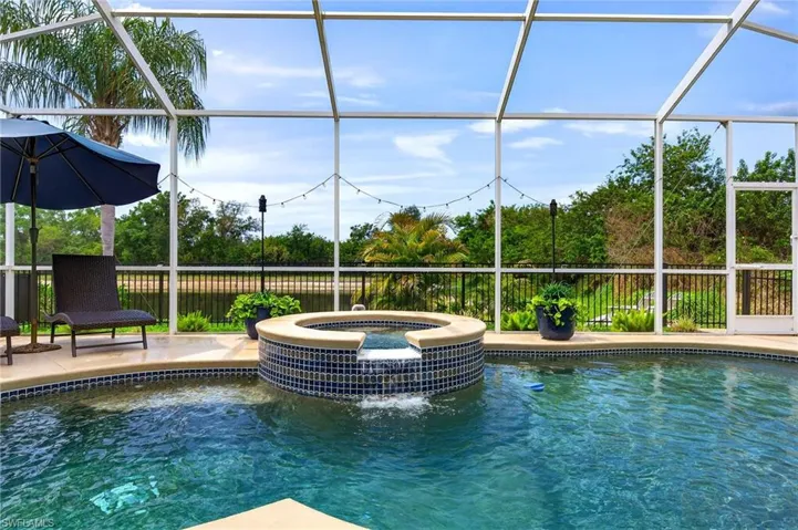 Integrated pool / spa featuring a lanai and a sunroom
