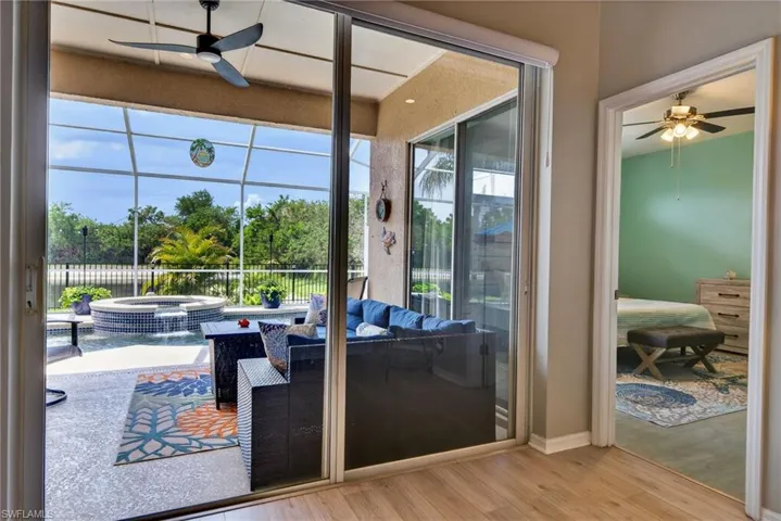 Doorway to outside with a ceiling fan and wood finished floors