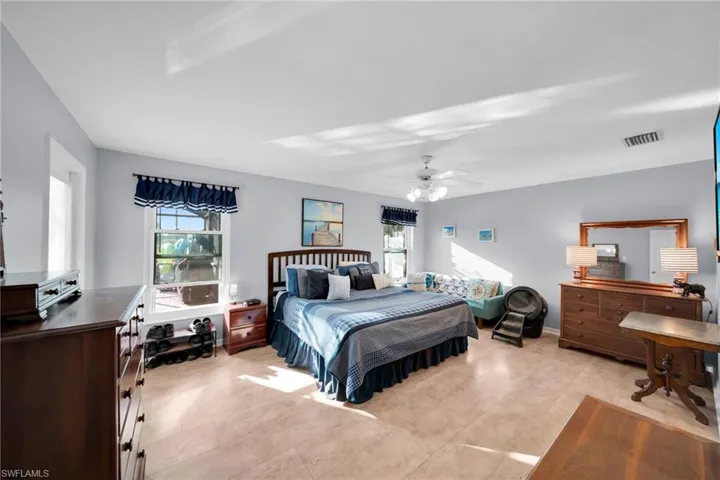 Oversized Master Bedroom with both Pool and Fresh Water Canal View, Door to Screened Lanai