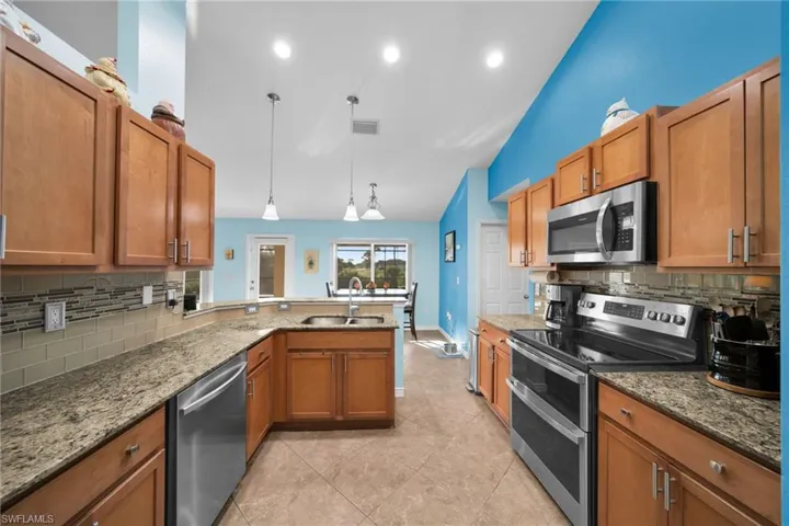 Kitchen with Stainless Steel Appliances, Fridge and  Stove do not convey~ Will replace with different stainless steel appliances. Shaker cabinets with granite counters