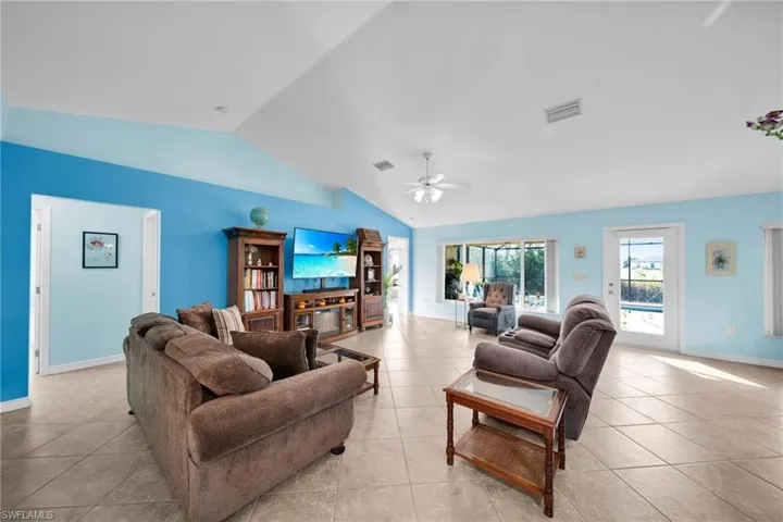 Great Room, Vaulted Ceiling, Big Hurricane Resistant Windows and Door, Tile Flooring.