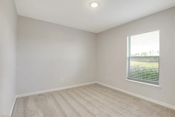 Spare room featuring light colored carpet