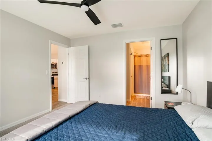 Bedroom with ensuite bathroom and ceiling fan