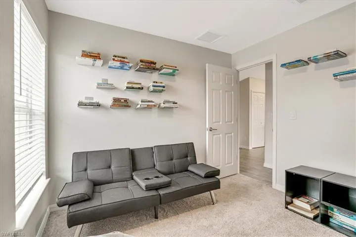 Carpeted living room with plenty of natural light