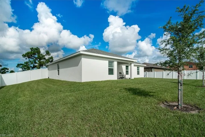 Rear view of house with a yard
