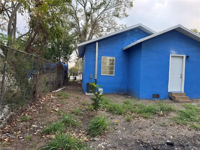 View of home's exterior with stucco siding and entry steps