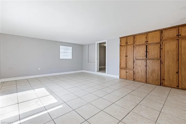 Unfurnished bedroom with light tile floors