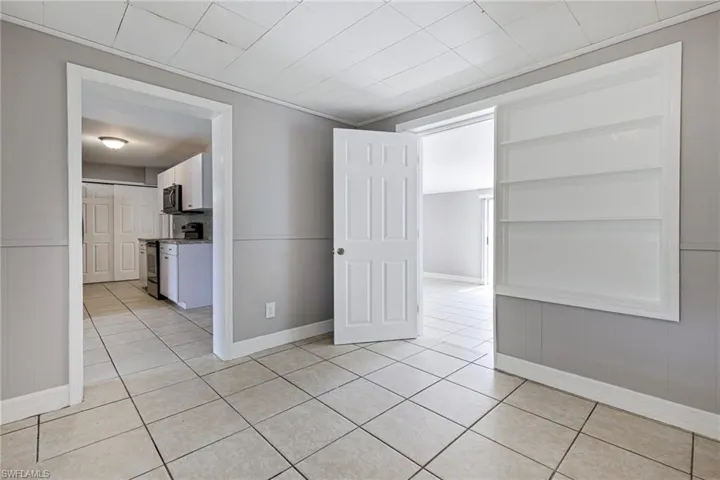 Empty room featuring light tile floors