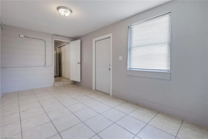 Empty room with light tile floors