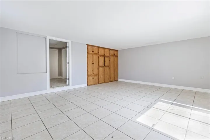 Unfurnished bedroom with light tile flooring