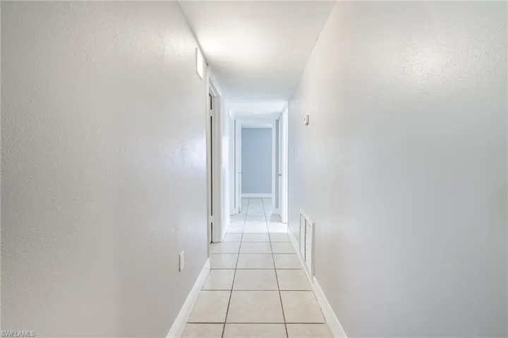 Corridor with light tile floors
