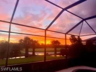 Pool at dusk featuring a lanai