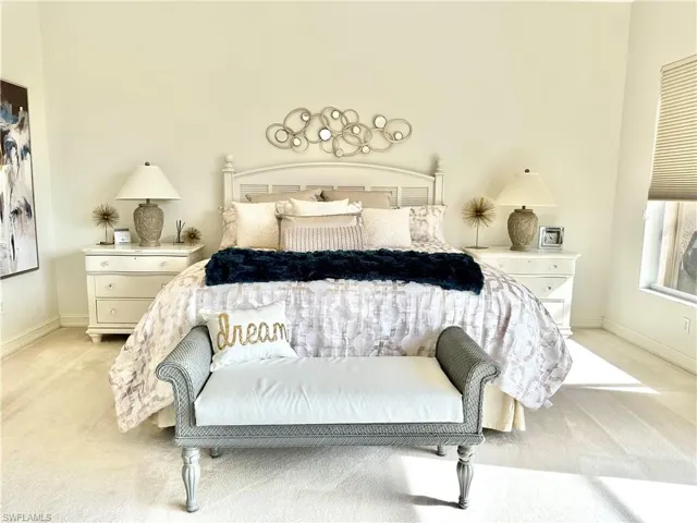 Bedroom featuring light carpet
