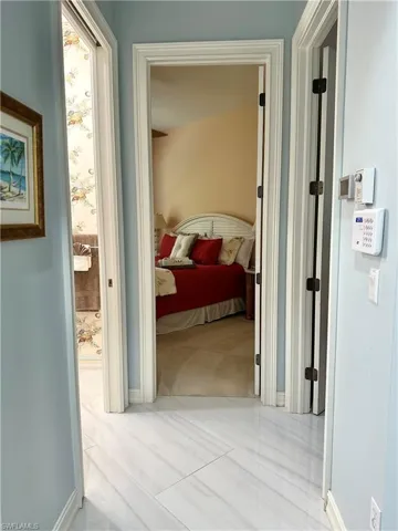 Corridor featuring light tile patterned flooring
