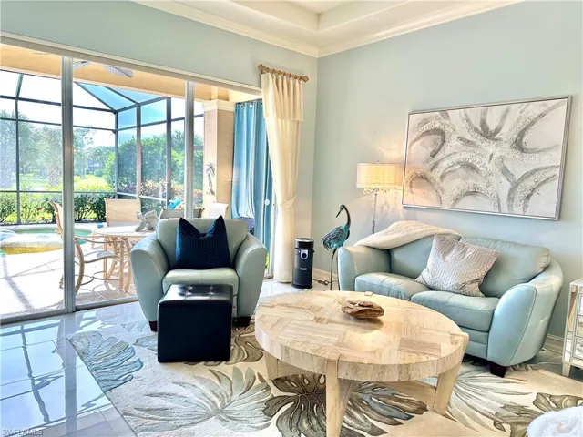 Tiled living room featuring crown molding