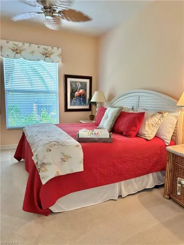 Carpeted bedroom with ceiling fan