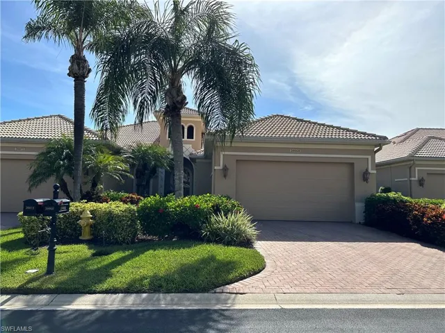 View of front facade featuring a garage and a front yard